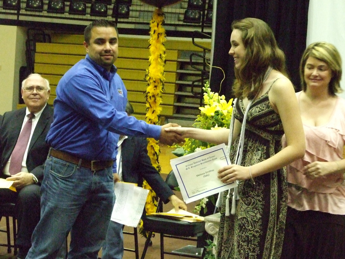 Image: Diego Garcia delivers the M.E. Singleton Scholarship to Melissa Smithey.