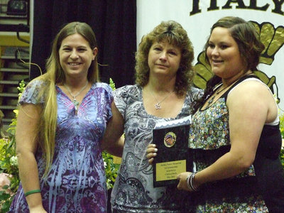 Image: Cynthia Nance and daughter, Rachel, give the Shelley Nance Memorial Scholarship to art student, Chelsea Beets.