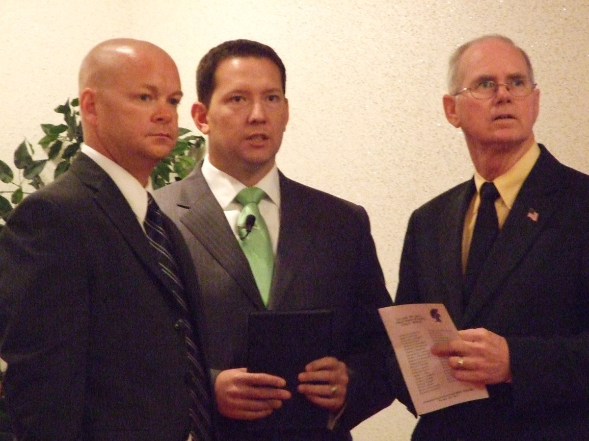 Image: Michael Chambers, Pastor Todd Gray and Pastor Ronnie Dabney watch the seniors come down the aisle to their seats.