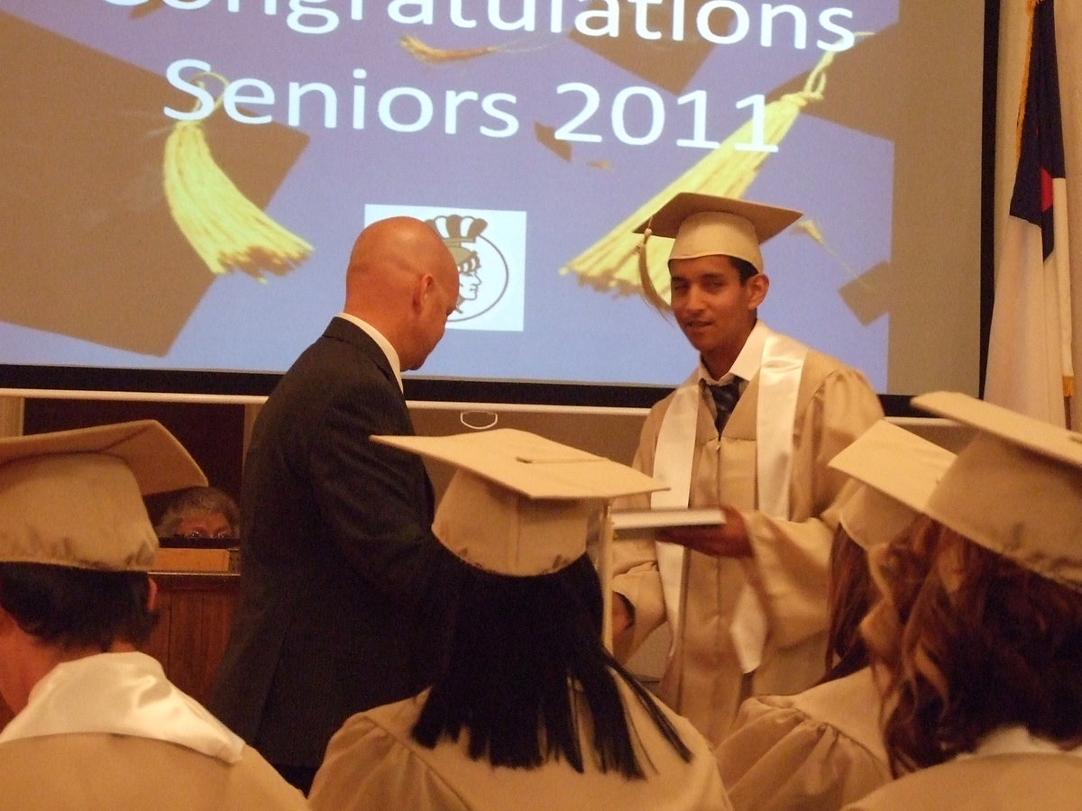 Image: Michael Chambers helps deliver the bibles to each student.