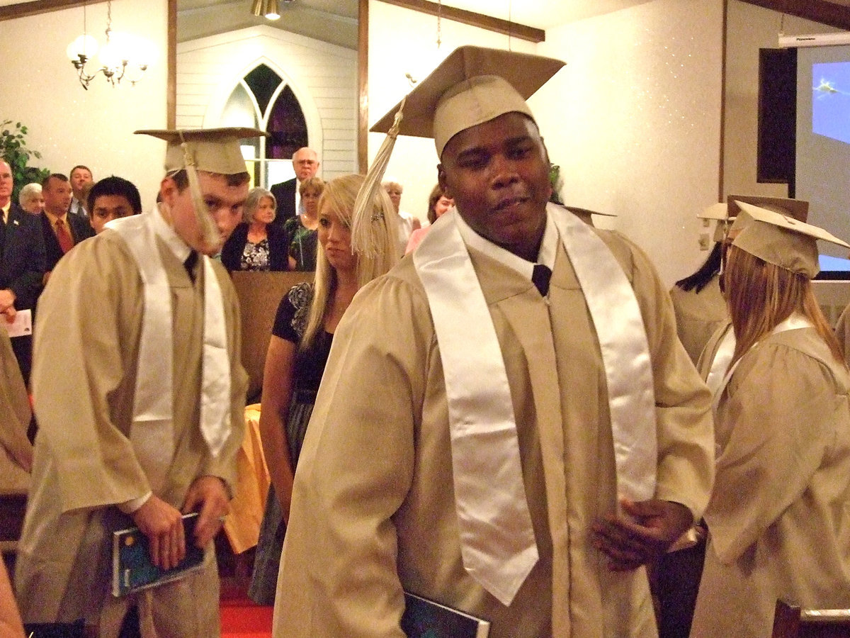 Image: Graduate Bobby Wilson makes his way down the aisle to the reception.