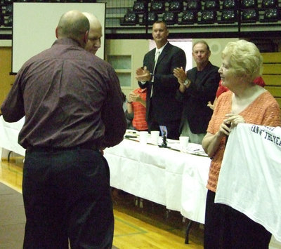 Image: Previous winner, Birdie Bell, looks on as Erick Thompson awards Richard Cook Fan of the Year.