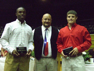 Image: Coach Bales awards Football Offensive MVP to Ethan Simon and Football Defensive MVP to Jasenio Anderson.