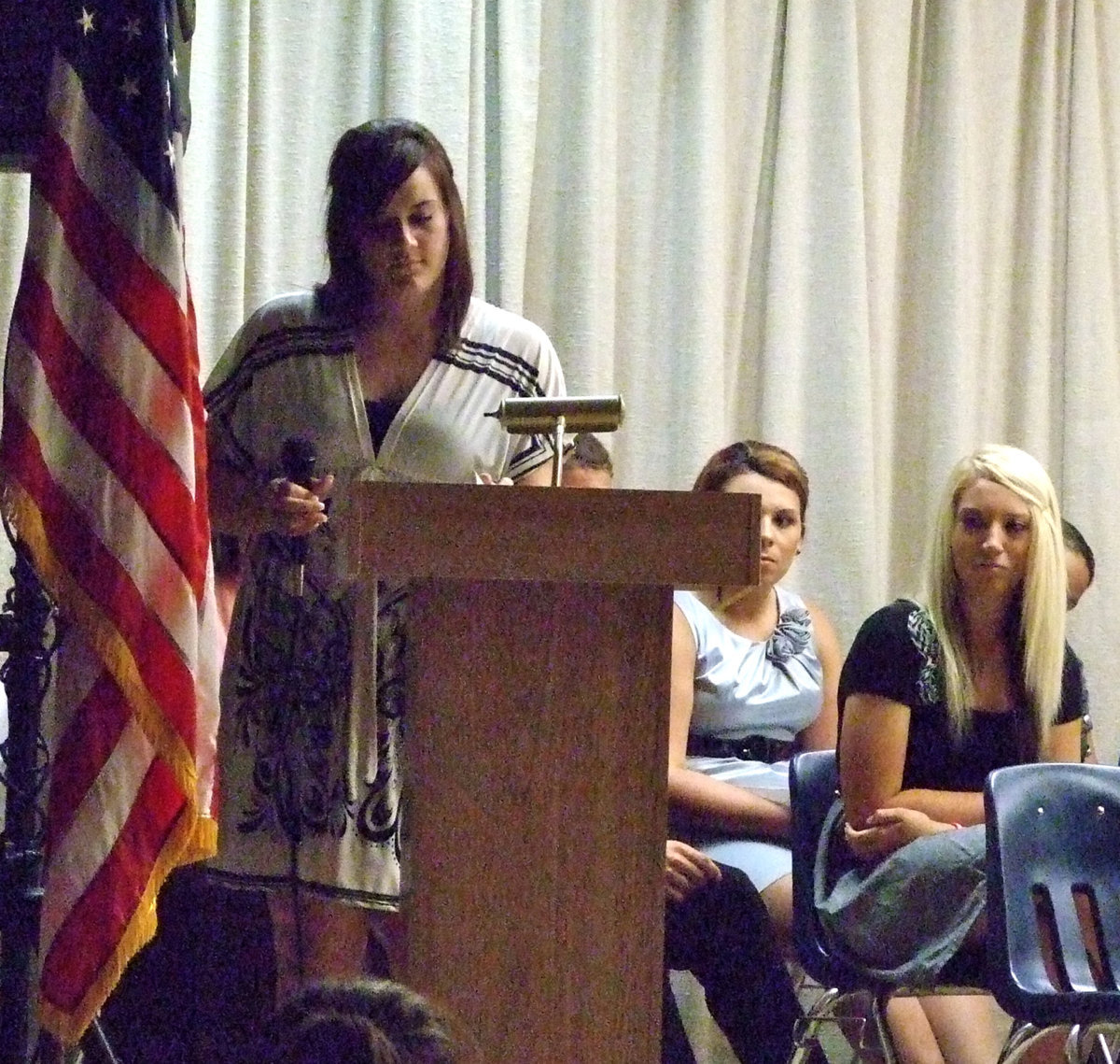 Image: Kaytlyn Bales organizes the induction ceremony.