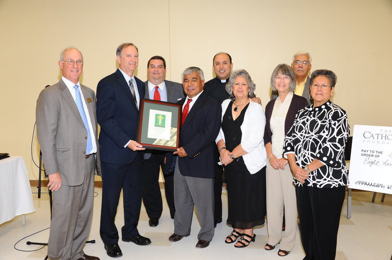 Image: From left: Ed Schaffler, president and CEO of The Catholic Foundation; Floyd Elfrink, Epiphany Mission; Thomas W. Codd, distribution chair of The Catholic Foundation Board of Trustees; and Vicente Guerrero, Rev. Antonio Ormaza, Mary Jacinto, Carolyn Maevers, Lucio Jacinto and Paula Guerrero of Epiphany Mission, gather during the 2011 Spring Grant Ceremony. During the event, the Foundation presented Epiphany Mission with a grant in the amount of $37,500 for the renovations to their church building. The grant will be used for painting of the church interior and exterior and new cabinets in the Sacristy.