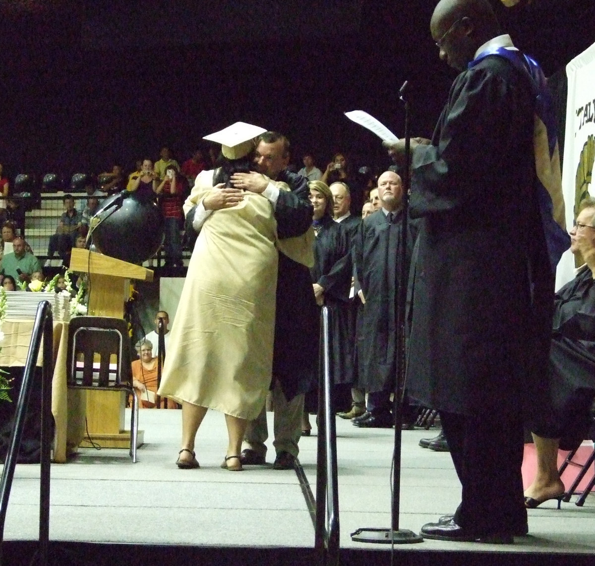 Image: Nikki Brashear gets a big hug from school board member, Paul Cockerham.