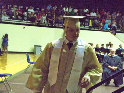 Image: Ethan Simon heads up the stairs for his diploma.