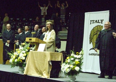 Image: Lisa Olschewsky leads the graduates in the school song.