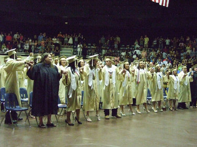 Image: The graduates connect during the school song.
