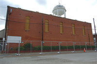 Image: A safety/security fence was erected around the structure before demolition began.