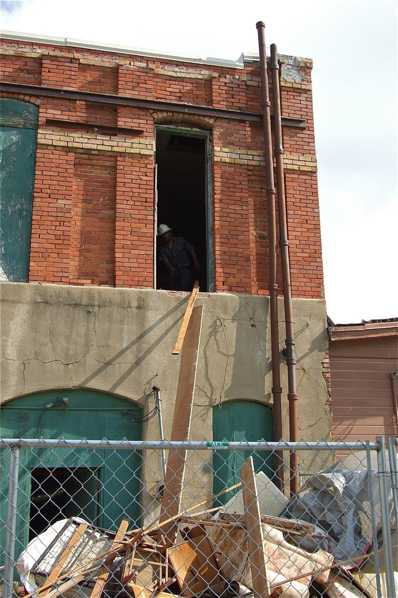 Image: Ceiling and floor boards are ripped out and thrown out the second-floor window.