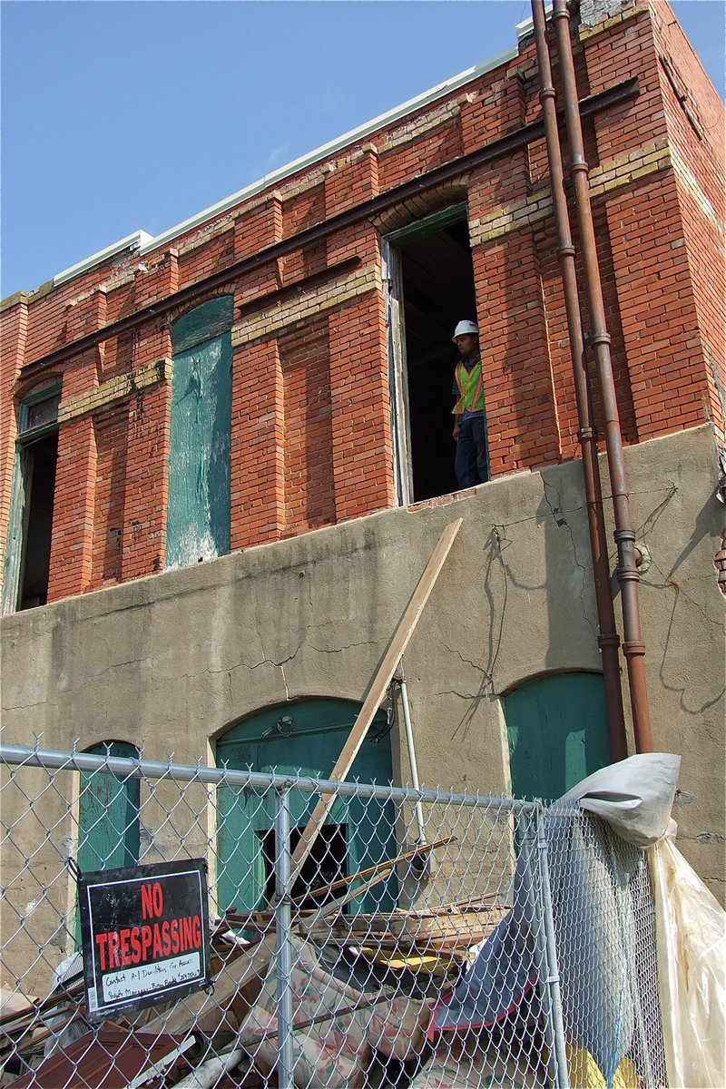 Image: An A-1 Demolition worker takes a moment to evaluate the carnage below.