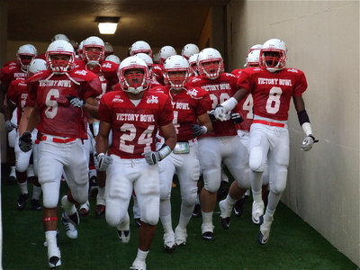 Image: Hillsboro’s Ronald Mitchell, Jr.(6), Temple’s Marquette Wilson(24), Milford’s Rolando Vega(4), Hico’s Dylan Turner(28), and Gene Gilbert Junior of Copperas Cove lead their FCA Red Team out of the tunnel and onto the field to start the second half.