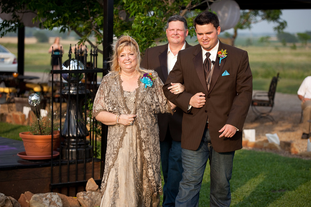 Image: Groom, Andrew, escorts his mom, Trina and dad, Russell Harlow, to their seat.