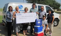Image: Paula Baucum, Meals-on-Wheels Board Chair, Kevin Blankenship of Ash Grove and Meals-on-Wheels staff accept donation.