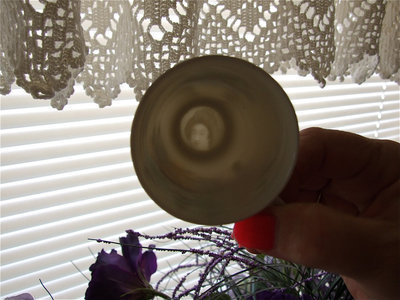 Image: Upon holding this porcelain cup up to the light, an image of a japanese woman is revealed.