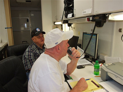 Image: From inside the Ennis Fire Department Command vehicle, Joe Frizzell, and, Bill Cleaver, check in with fellow members of the Ellis County Amateur Radio Club who are scattered along the 4 separate sightseeing bicycle routes during Tour d’Italia. E.C.A.R.C. currently has 62 members and also assist in weather spotting and in communications during emergencies.  