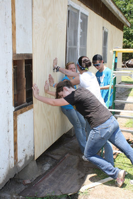 Image: The youth are holding up the side of the house.