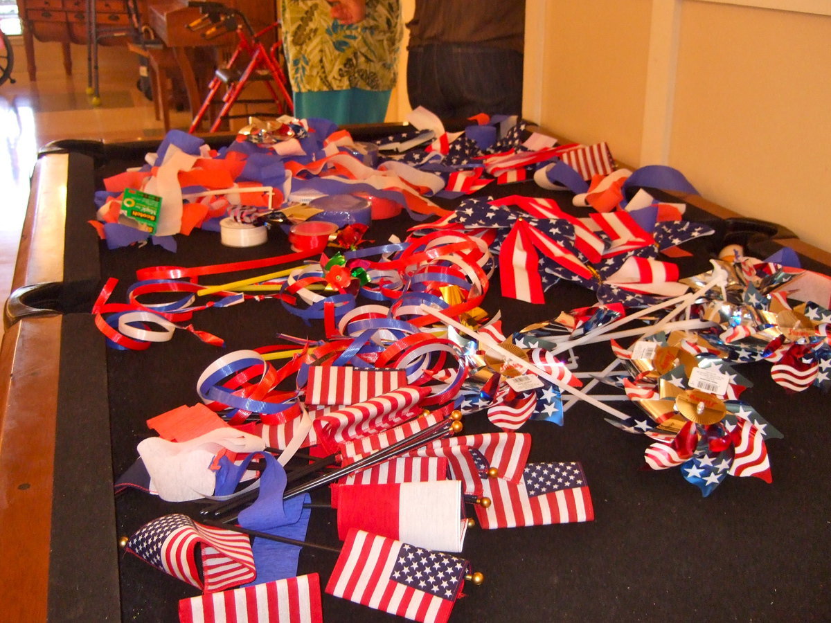 Image: Festive red, white and blue streamers, pinwheels and  U.S. flags adorned Trinity Mission while residents were celebrating the Fourth of July with.