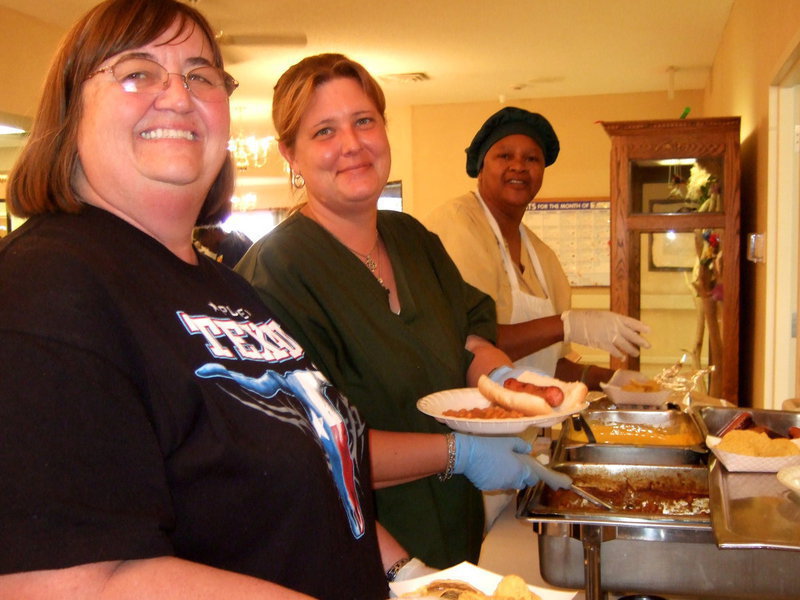 Image: Staff members of Trinity Mission are lending a helping hand serving up a wonderful Fourth of July lunch for the residents.