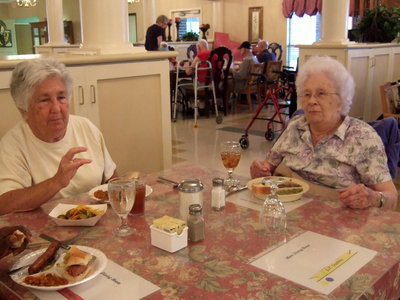 Image: Mrs. McGregor (volunteer) and Margaret Oliphant (resident) enjoying their Fourth of July meal.