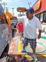Image: 2010 Car Wash  IHS Band Director, Jesus Perez uses some elbow grease to wash a car that came thru the car wash last year.