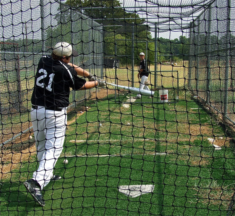 Image: Bailey Walton pitches to teammate Kevin Roldan in the batters cage before a doubleheader between Italy and Alvarado’s freshman and varsity squads.
