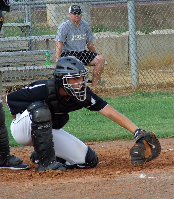 Image: Brandon Souder gets the job done behind the plate while Team Italy’s biggest fan looks on. 