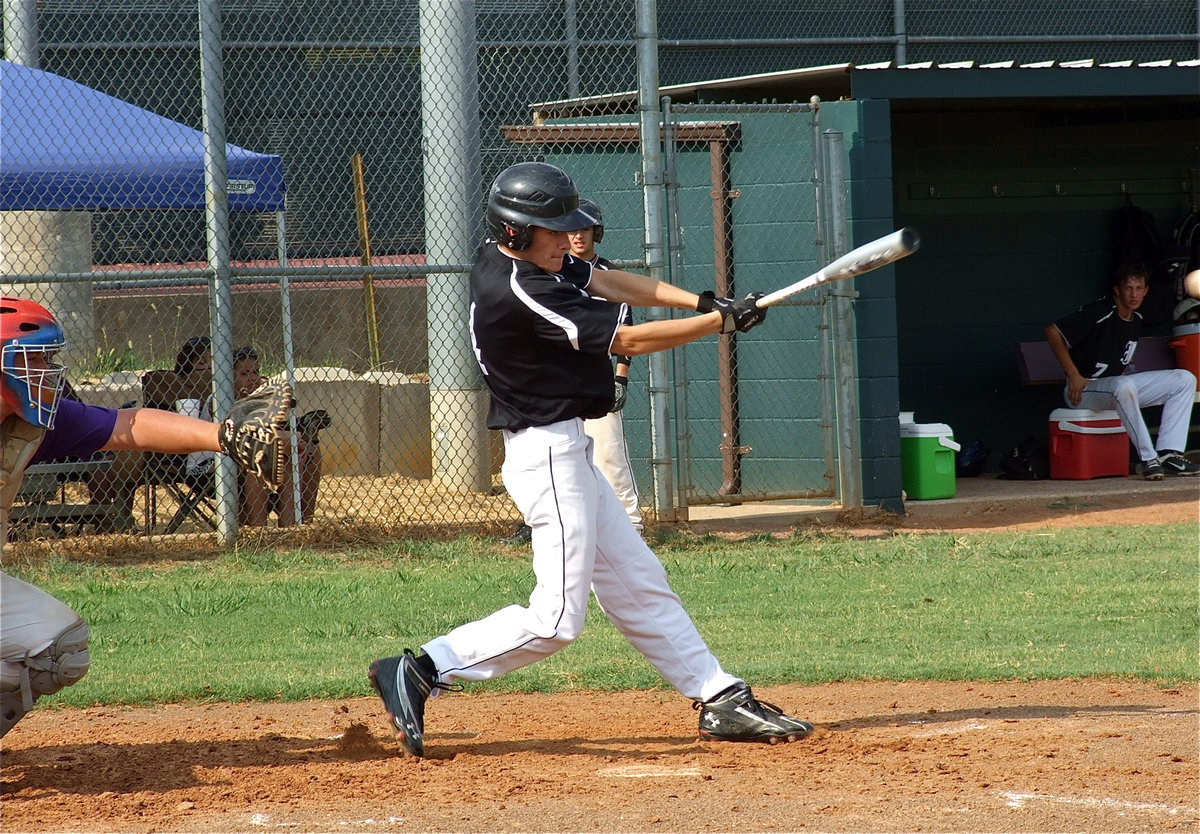 Image: Justin Wood blasts a shot thru Alvarado’s defense.