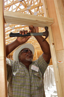 Image: Ervin Green, Sr., a member of the Mt. Gilead Baptist Church, lends his hands to the project.