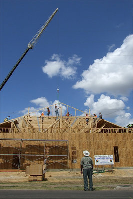 Image: Ervin Green, Sr. takes in the moment as the roof of the new church begins to take shape.