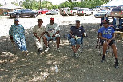 Image: Members of the Mt. Gilead Missionary Baptist Church take break while watching the new church reach heaven right before their eyes.