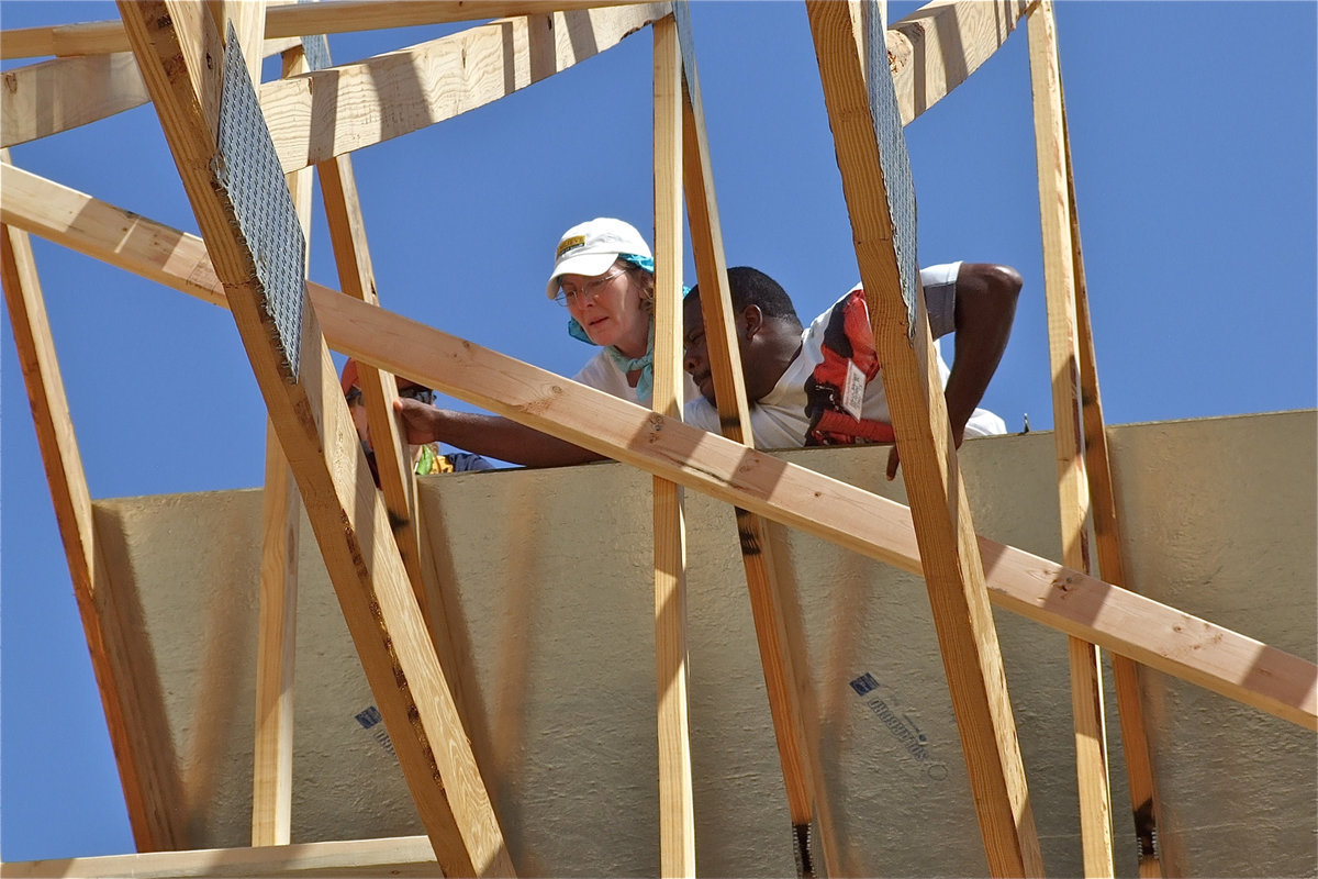 Image: Edwin Wallace, a member of the Mt. Gilead Baptist Church, helps with the roofing of the new church.