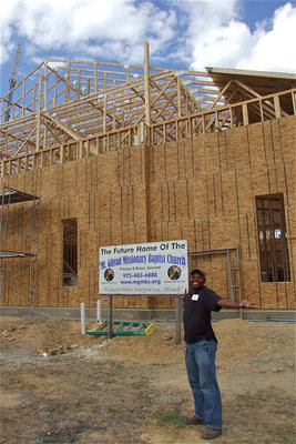 Image: Bryant Cockran, a member of the Mt. Gilead Baptist Church, is overwhelmed while standing in front of the massive new church.
