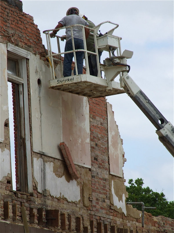 Image: Bricks continue to tear drop to the ground.