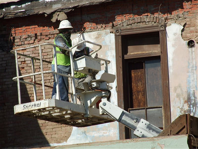 Image: A snorkel helps workers reach the top of the remaining wall.