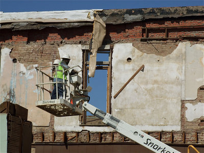 Image: Getting there: Demo crews relentlessly strip away the building piece by piece and brick by brick and memory by memory.