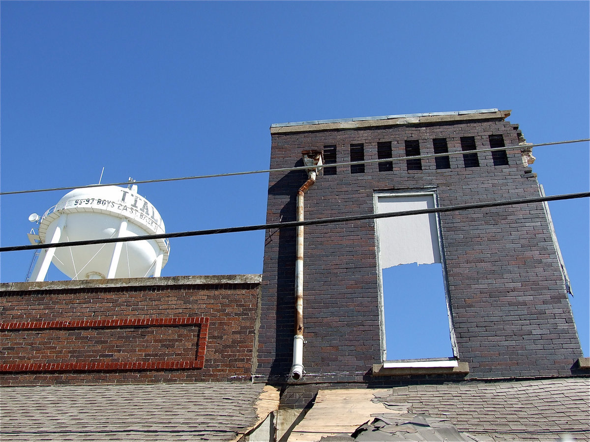 Image: The last wall section of the upper floor makes one last proud stand alongside the water tower.