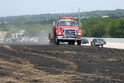Image: Still checking for signs of flames as traffic slowly passes by on the highway.