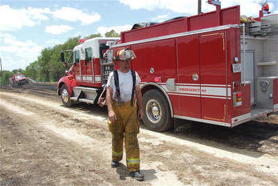 Image: Italy firefighter, Brad Chambers, gets prepared to clear the scene.