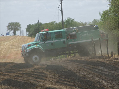Image: The Texas Forest Service exits the pasture to return to Hillsboro. The TFS will remain in Hillsboro until enough rainfall dampens the region and reduces the risk of fast-spreading grass and wildfires.