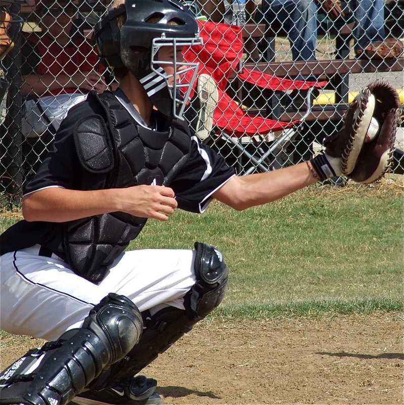 Image: Ross Stiles, squeezes a strike from pitcher Brandon Souder.