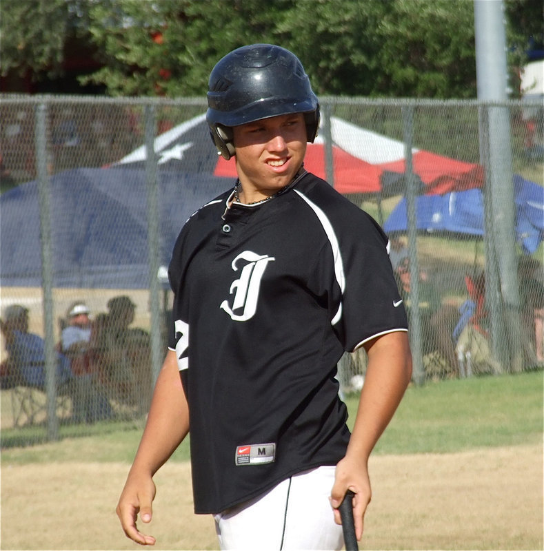 Image: Kyle Jackson checks with the coaches before taking his at bat.