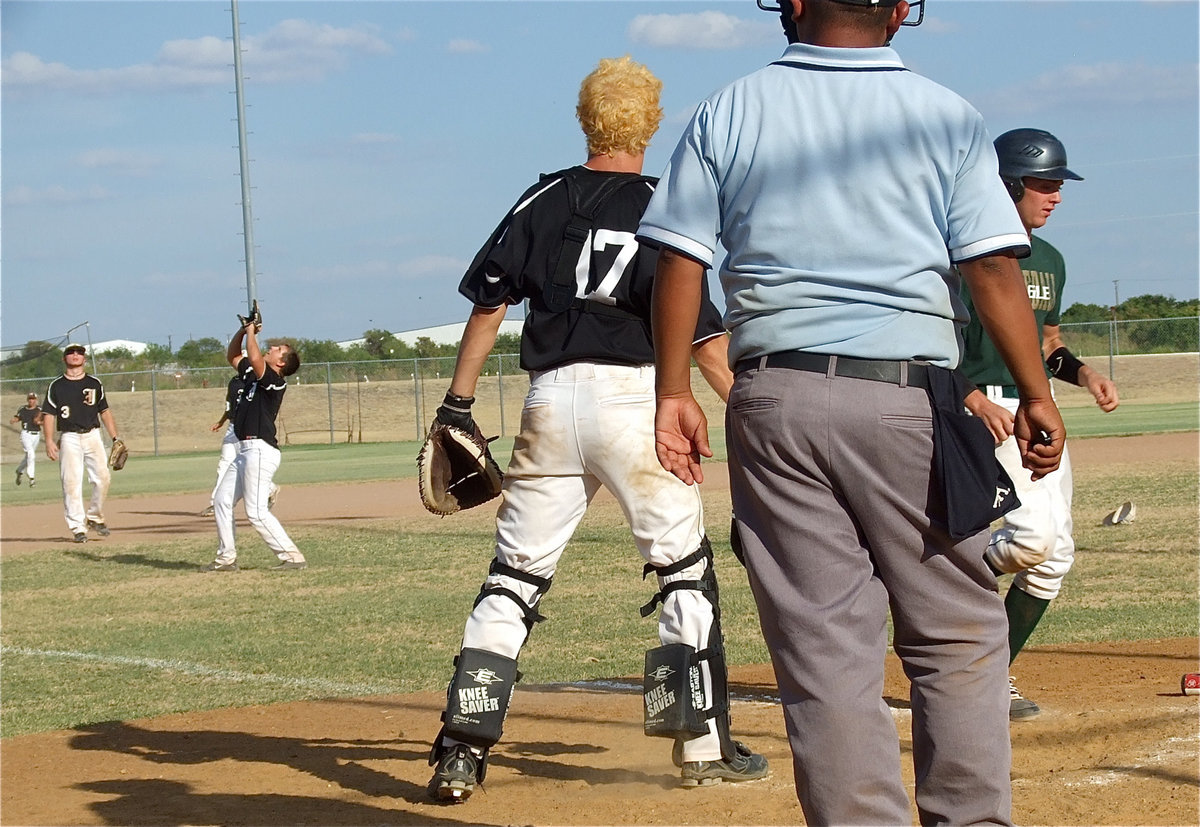 Image: Catcher Brandon Souder(17) and third baseman Reece Marshall(3) look on as pitcher Kyle Jackson(2) catches a pop-up for out number three.