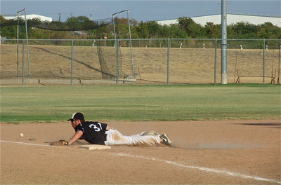 Image: Reece Marshall makes a diving attempt at a line drive hit down the third base line.