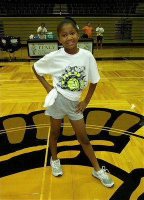 Image: Destiny Harris shows off her Italy Volleyball Camp T-shirt.