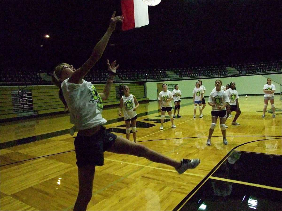 Image: Halee Turner shows her athletic ability as she stretches to keep the ball in play.