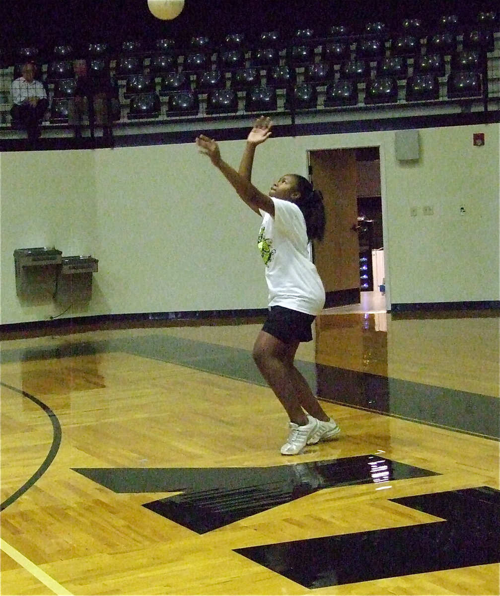 Image: Kennedy Miller prepares to serve.