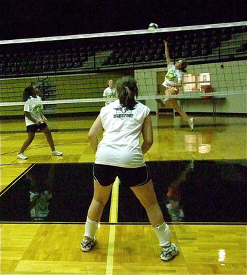 Image: Lady Gladiator and camp coach Bailey Bumpus demonstrates how to attack the ball.