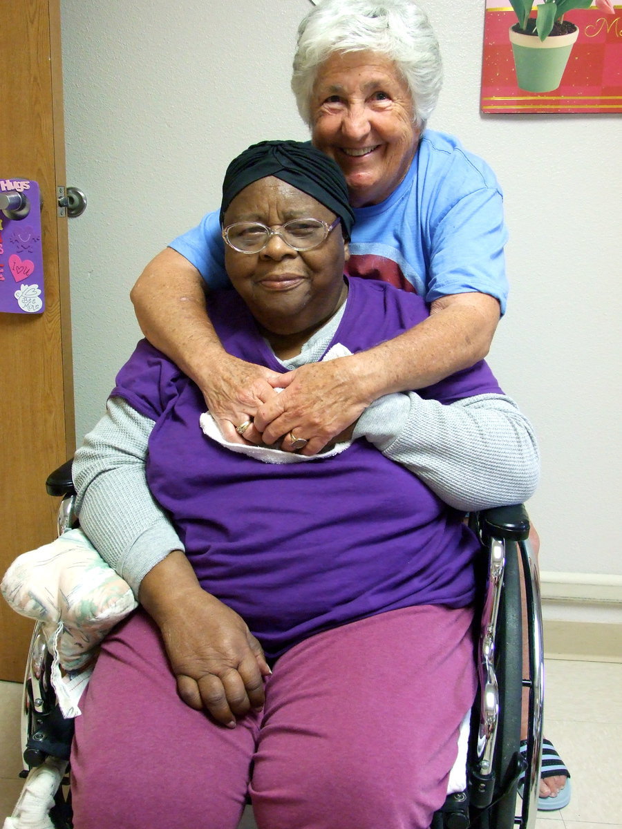 Image: Mable and Dow Anna enjoying a hug while they get their picture taken.